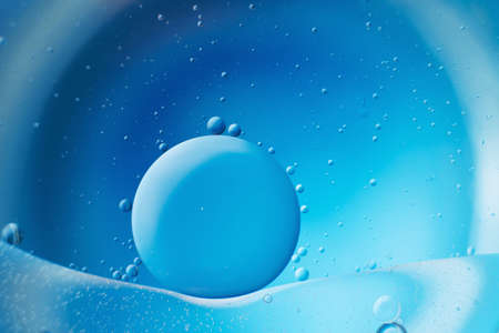 abstract light blue background with oil circles . bubbles of water close up .の写真素材