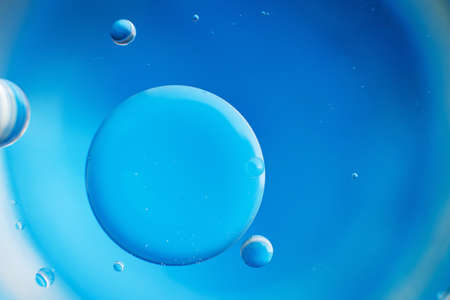 abstract light blue background with oil circles . bubbles of water close up .の写真素材