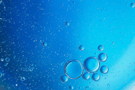 abstract light blue background with oil circles . bubbles of water close up .の写真素材