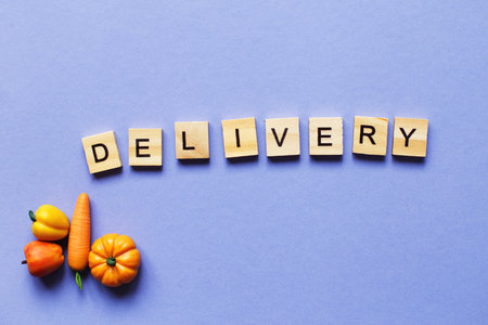 inscription delivery with vegetables and fruits on purple background. delivery service concept.の写真素材
