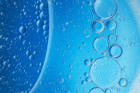 abstract light blue background with oil circles. bubbles of water close up. oil bubbles in the water macro.の写真素材