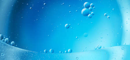 abstract light blue background with oil circles. bubbles of water close up. oil bubbles in the water macro.の写真素材