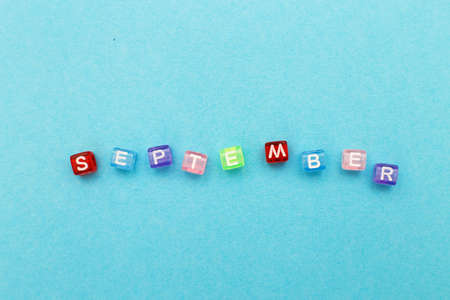 inscription September made by multicolor plastic cubes on a blue backgroundの写真素材