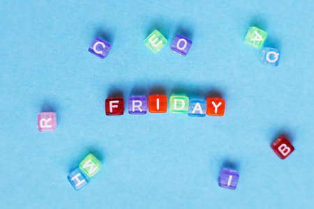 inscription friday made by multicolor plastic cubes on a blue backgroundの写真素材