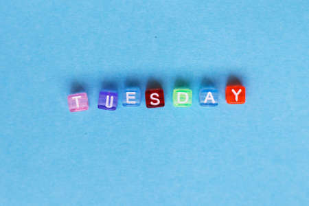 inscription Tuesday made by multicolor plastic cubes on a blue backgroundの写真素材