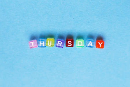 inscription thursday made by multicolor plastic cubes on a blue backgroundの写真素材