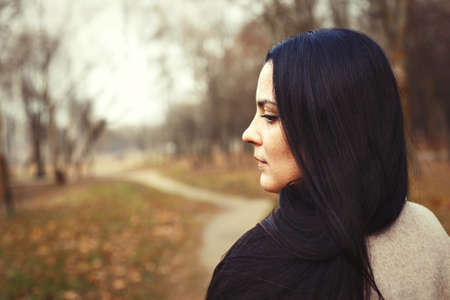portrait of brunette woman with thick beautiful long hair close outdoor.の写真素材