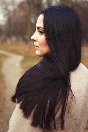 portrait of brunette woman with thick beautiful long hair close outdoor.の写真素材