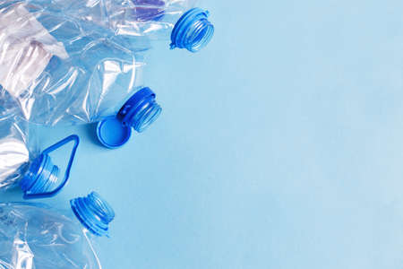 a lot of plastic empty rumpled used bottles on a blue background. waste and pollution concept.の写真素材