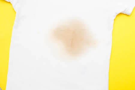 dirty stain on a white clothes on yellow backgroundの写真素材