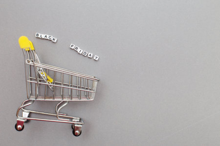 The metal shopping cart on a gray background. black friday sale concept.の写真素材