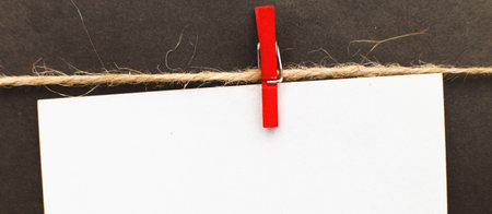 sticker with empty mockup for text hanging on a pin on black backgroundの写真素材