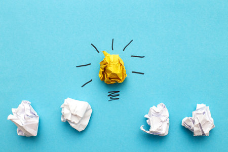 crumpled yelllow and white paper lightbulb as a concept creative idea and innovation.の写真素材