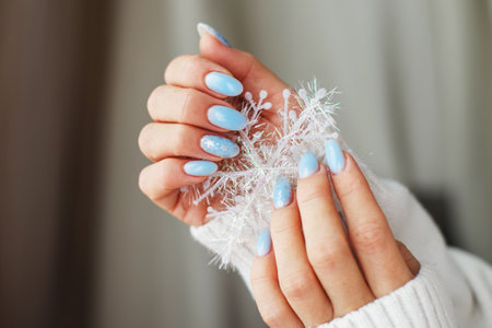 Cozy nails with winter manicure with snowflakes.の写真素材