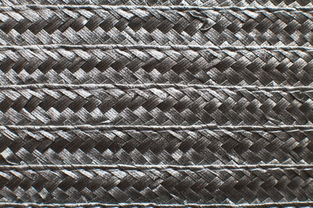 Black textured surface of wicker woven basket.