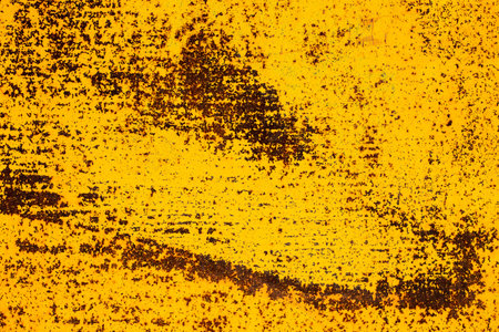 Orande fiery rusty abstract painted metal plate texture and background. Yellow texture of grunge old plate with stained cracked paint and brown rust.の写真素材