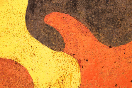Color rusty abstract painted metal plate texture and background. Yellow, black and orange texture of grunge old plate with stained cracked paint and brown rust.の写真素材