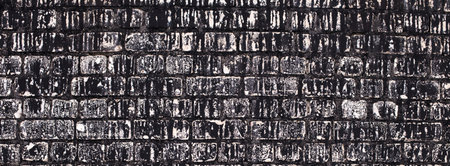 Old brick black color wall background. Dark stone textureの写真素材