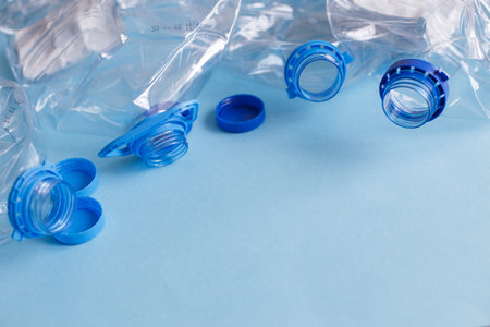 a lot of plastic empty rumpled used bottles on a blue background. waste and pollution concept.の写真素材