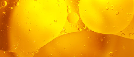 Gold Oil bubbles close up. circles of orange water macro. abstract shiny yellow background. bannerの写真素材