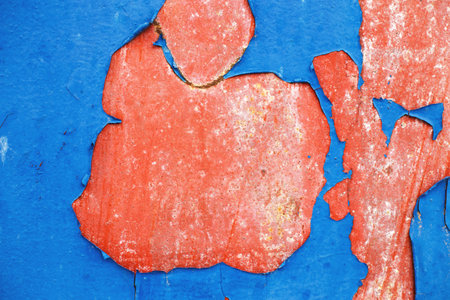 Old blue paint peeling from red concrete wall background. Texture of an old grunge plate with cracked paint with a hole. copy space for your text.の写真素材