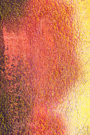 Decorative plaster concrete colorful background. Multicolor yellow red and brown wall close up.の写真素材