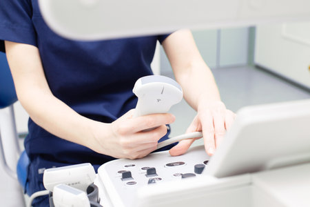 Female doctor sitting in office in a hospital doing ultrasound scanning diagnosticの写真素材