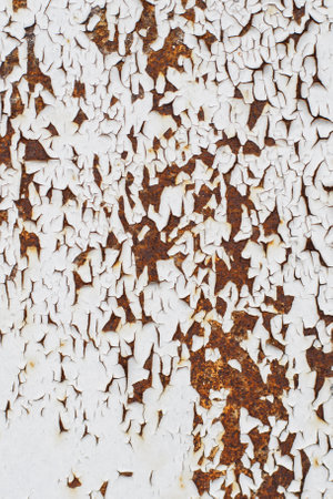 Rusty metal abstract background. Texture of an old grunge metal plate with cracked paint. Rusted white and browm painted wall.の写真素材