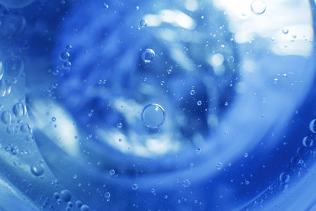 Oil bubbles close up. a circles of water macro. abstract light blue backgroundの写真素材