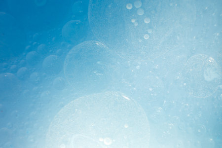 Oil bubbles close up. a circles of water macro. abstract light blue backgroundの写真素材