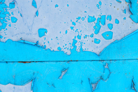 Old blue turquoise paint peeling from concrete or metal wall background. Texture of an old grunge...