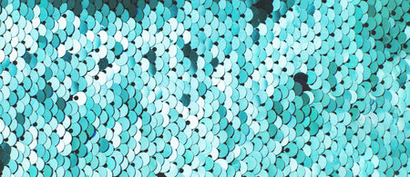 Green abstract sequins sparkling background. Texture of sequins. Holiday wallpaper with pattern of...