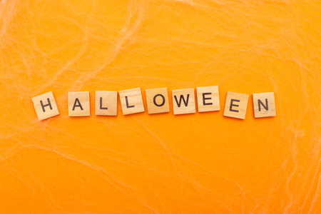 the inscription halloween sale on orange background with spider web.の写真素材