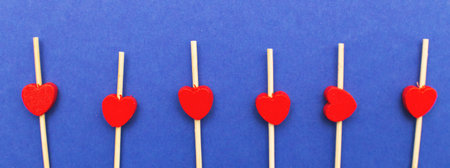 Valentine's Day background. Wooden red hearts on a blue background with copy space for text. Love, romance concept. Bannerの写真素材