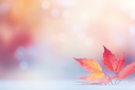 Autumn background. Branch of red and pink leaves on a bush on a blurred pink and red background. Beautiful vibrant blurred bokeh for autumn designの素材