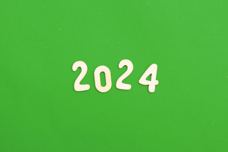 Wooden numbers 2024 on green background. Christmas, New Year, winter holidays sale and festive mood concept.の写真素材