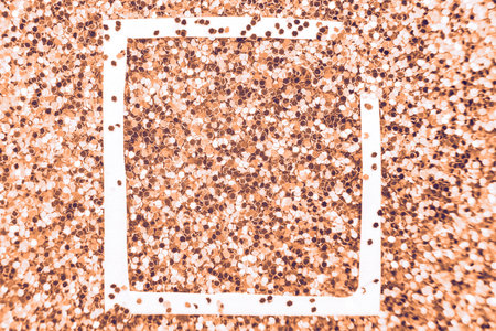 glittering background of a Peach Fuzz sequins closeup. Sparkle festive texture. white frame for your text. Color of the year 2024の写真素材