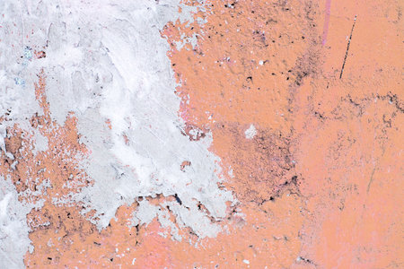 old Peach Fuzz cracked concrete background. a gray concrete wall closeup. Color of the year 2024の写真素材