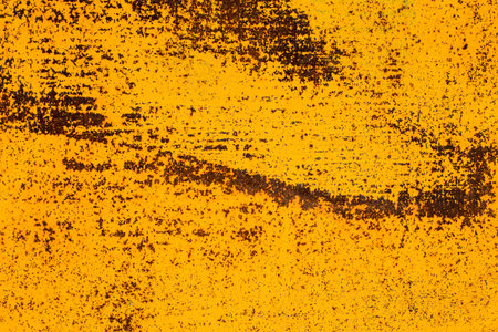 Orande fiery rusty abstract painted metal plate texture and background. Yellow texture of grunge old plate with stained cracked paint and brown rust.の写真素材