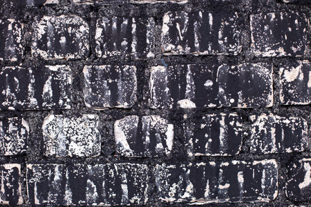 Old brick black color wall background. Dark stone texture.の写真素材