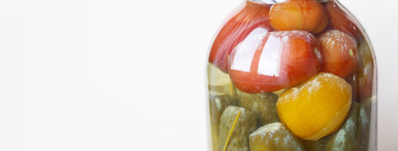 Glass jar with homemade pickled tomatoes and cucumbersの写真素材