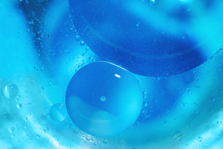 abstract light blue background with oil circles . bubbles of water close up . oil bubbles in the water macro. circle bubbles backgroundの写真素材