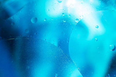 abstract light blue background with oil circles . bubbles of water close up . oil bubbles in the water macro. circle bubbles backgroundの写真素材