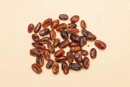 Dried dates on a light beige surface, healthy food concept