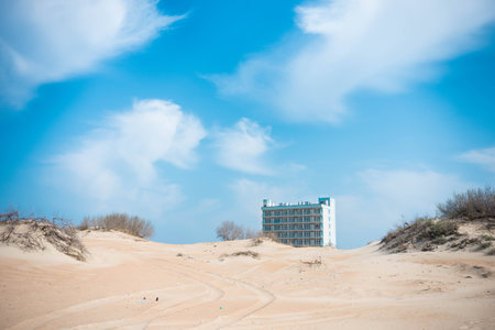 hotel on the beach is visible from behind the dunes