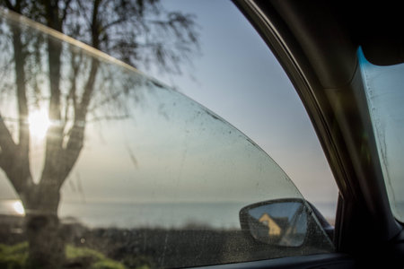 through the window of the car you can see a beautiful landscape, the driver arrived to the lakeの写真素材
