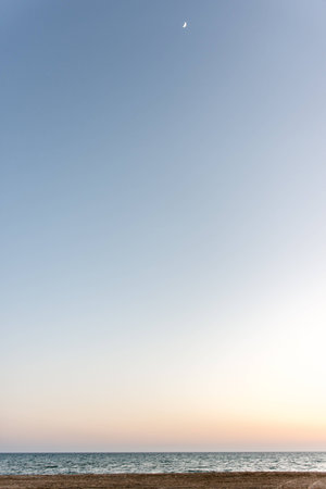 blue sea at sunset. the waves are to the shore. the sun over the horizonの写真素材