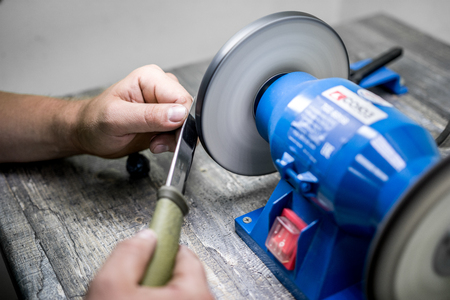 sharpening the knife with a special machineの写真素材