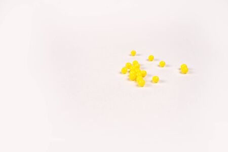 yellow vitamins lie on a white table