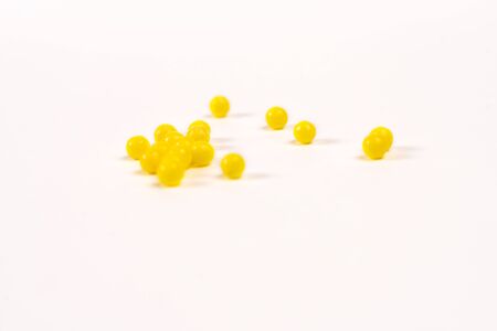 yellow vitamins lie on a white tableの写真素材